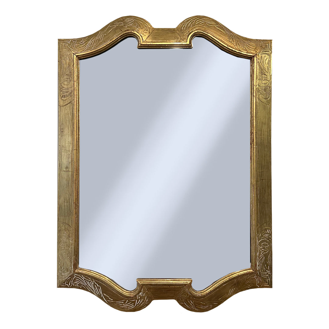 Decorative engraved gold-framed mirror on a white background