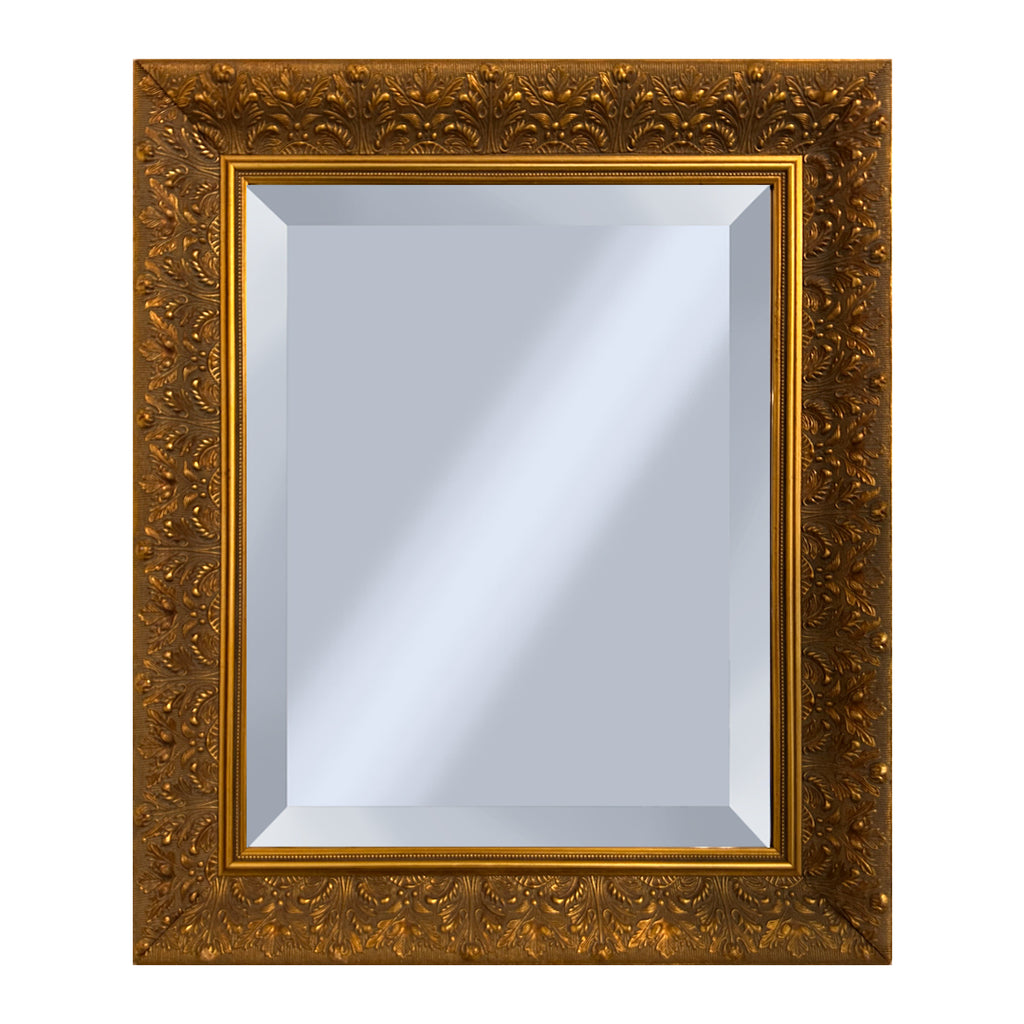 Decorative gold mirror with intricate floral patterns on a white background