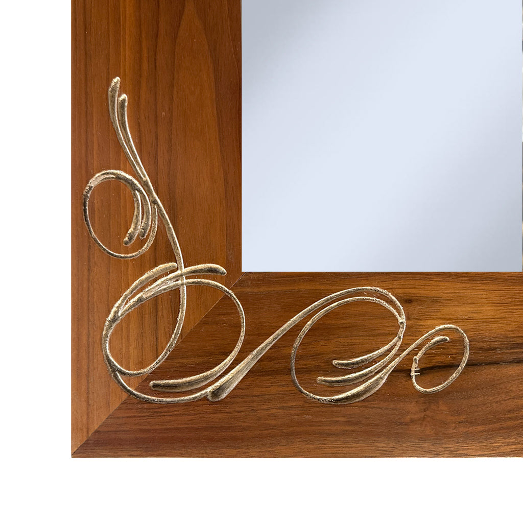Corner detail of silver engraved on wooden mirror