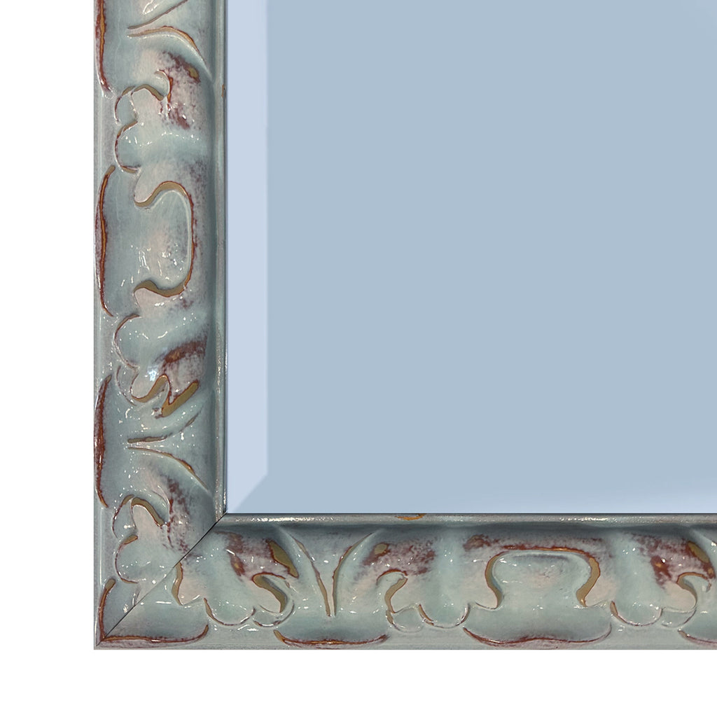 Corner detail of teal mirror on white back ground