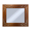 Wooden mirror with decorative silver carvings on a white background
